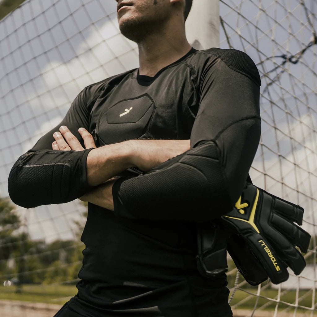 http://storelli.com/cdn/shop/articles/A_goalkeeper_wearing_a_snug_black_top_stands_with_his_arms_crossed._1024x1024.jpg?v=1679513347