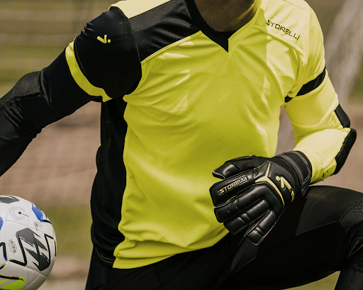 Young male soccer player in a bright yellow soccer jersey. 